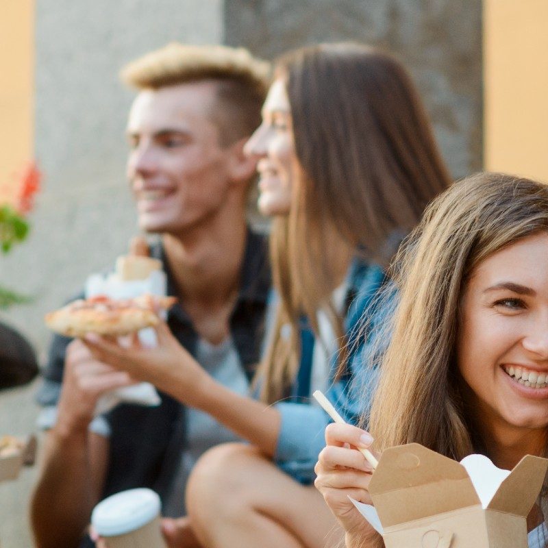 Group of students sitting eating together