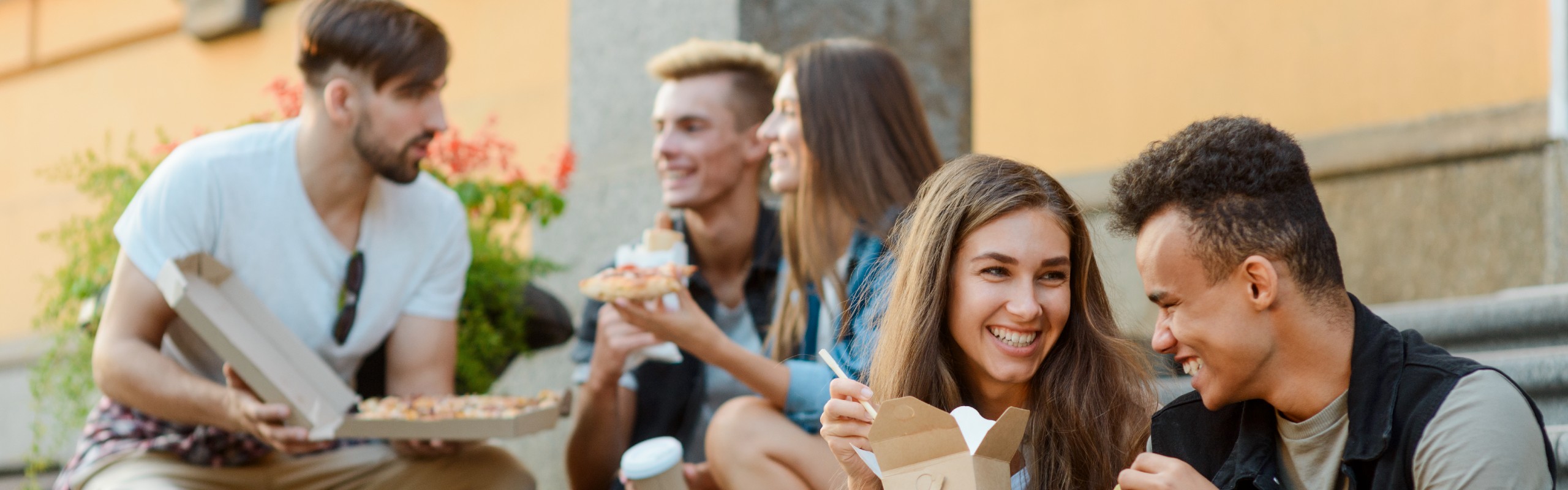 Group of students sitting eating together