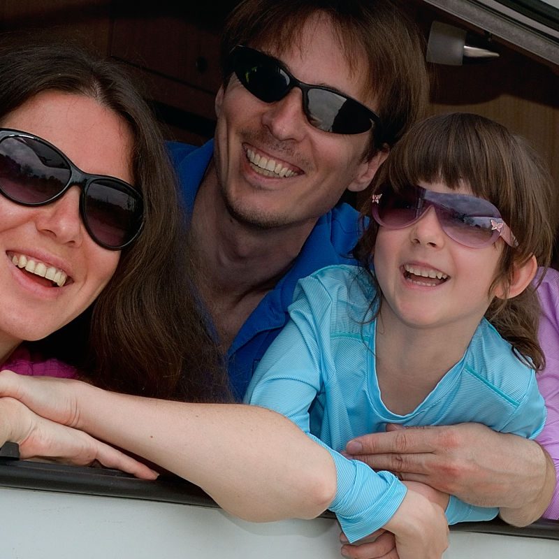 Family looking out of the window in their holiday caravan