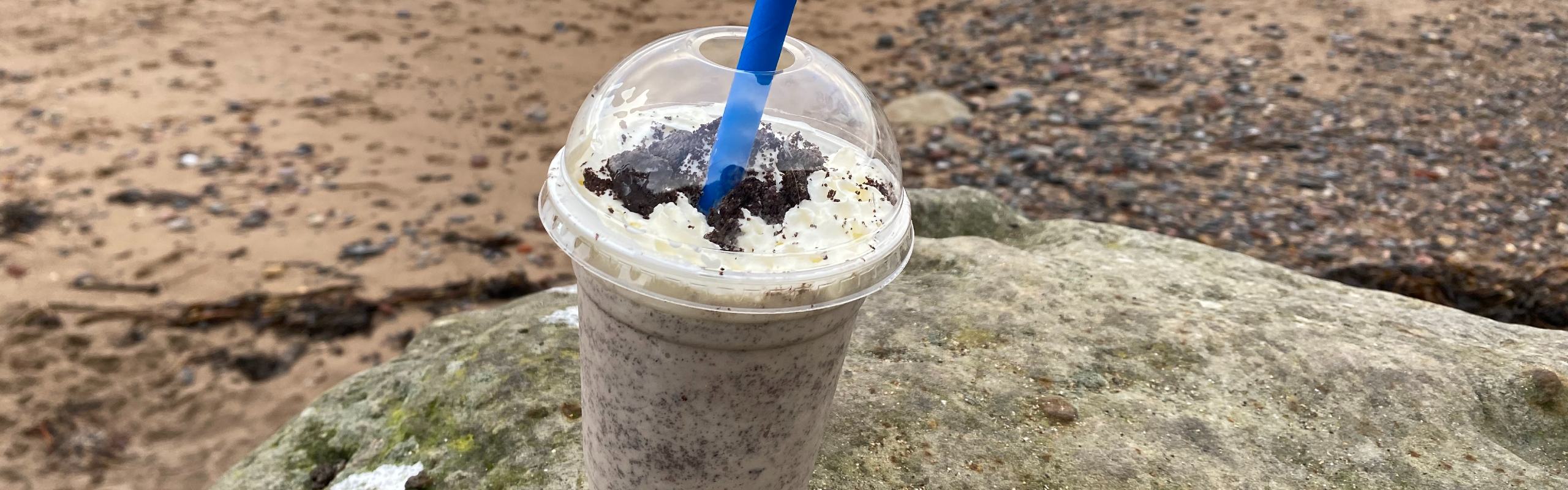 Photo of an oreo milkshake in a plastic cup