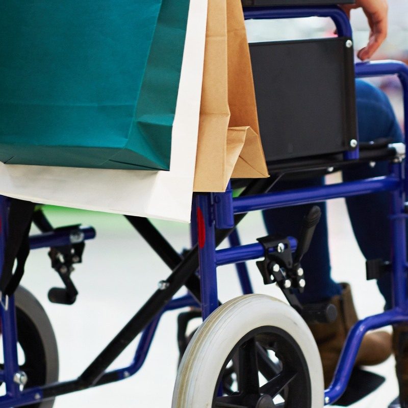 Person shopping with friend in wheelchair