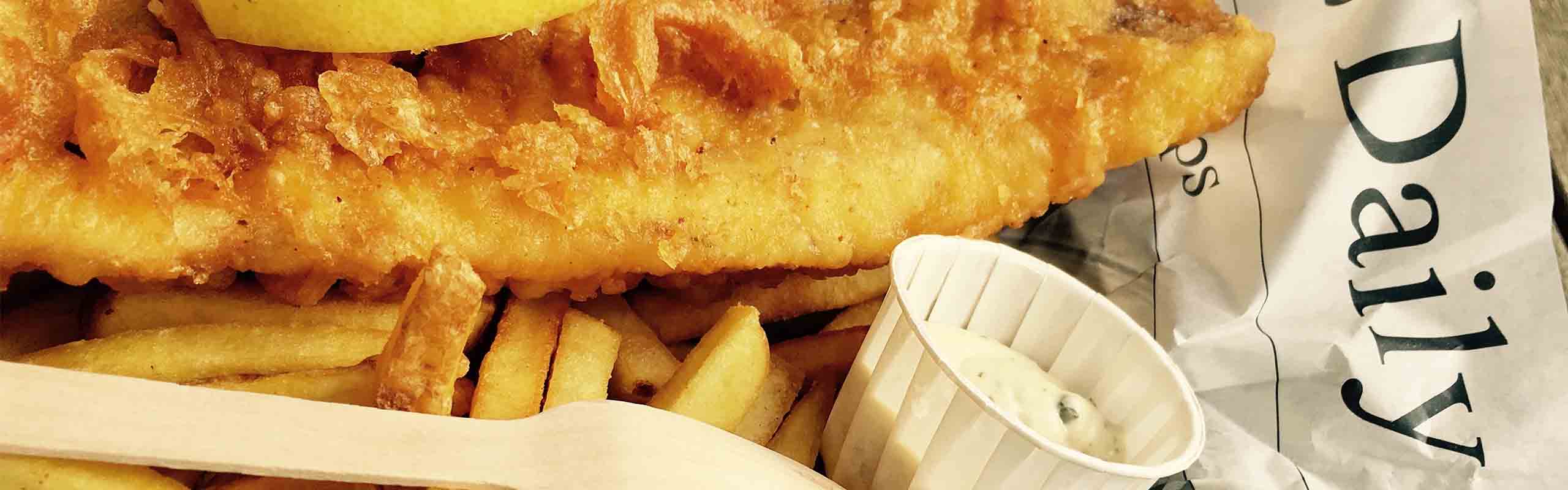 A fish and chips served on a newspaper